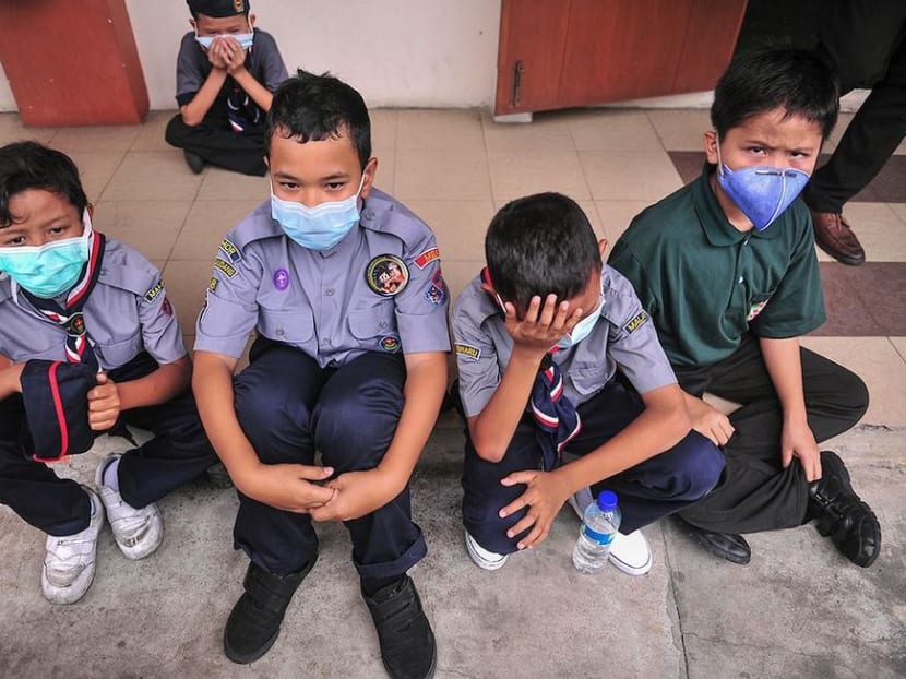 Students wearing masks as they receive medical treatment. A teacher says staff will have to clean up school equipment such as tables, chairs and curtains as the government’s safety assurance is only for air quality.