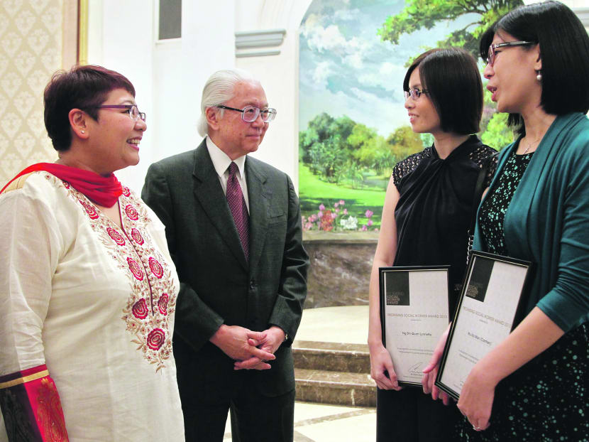 President Tony Tan with award recipients (from left) Ms Yogeswari Munisamy, Ms Lynnette Ng and Ms Carmen Wu after the ceremony at the Istana. Photo: Don Wong