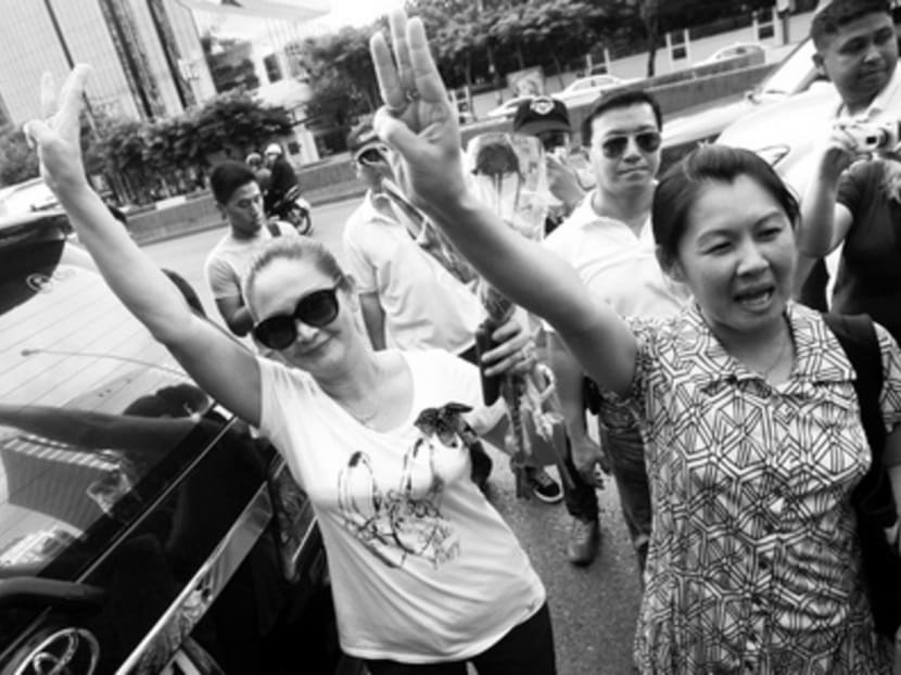 Thai protesters raising three fingers, a symbol of rebellion from The Hunger Games movie. Social media can contribute towards the opening up of a society that is under military rule. Photo: Reuters