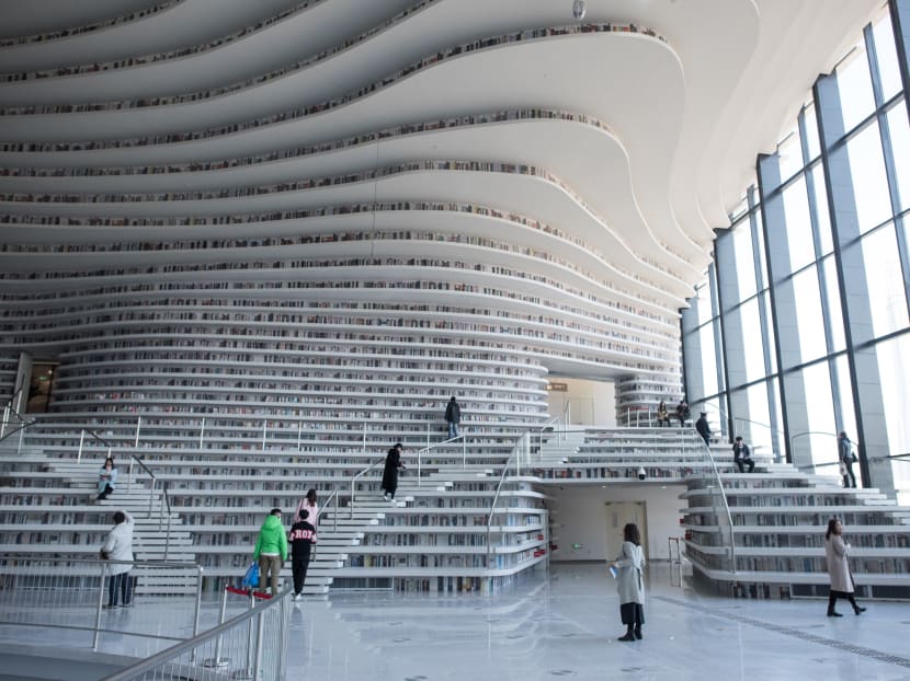 A futuristic Chinese library has wowed book lovers around the world with its white, undulating shelves rising from floor to ceiling. Photo: AFP