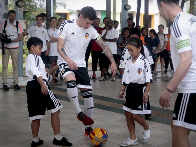 Valencia player Santi Mina taking part in a kickabout with kids on May 18, 2016. Mina was here with a few other Valencia players as part of promotional activities by the La Liga club, which included the announcement of the partnership between S.League club Geylang International and Valencia to run the Valencia Soccer School. Photo: Jason Quah