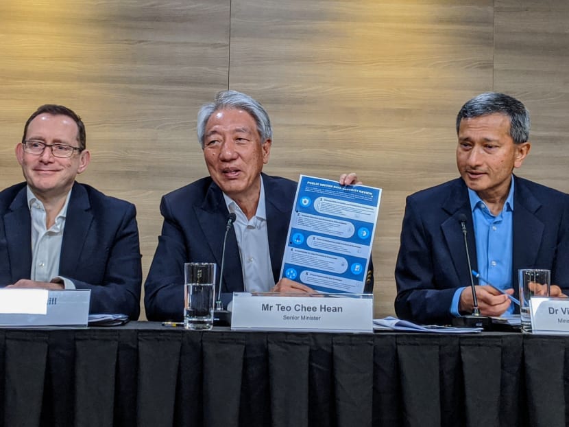 Senior Minister Teo Chee Hean holds up an infographic on the five recommendations by his committee to protect Singaporeans' data. Seen beside him are committee members (left) Mr David Gledhill, the former chief information officer at DBS; and Dr Vivian Balakrishnan, the Foreign Affairs Minister and Minister-in-charge of the Smart Nation initiative. Senior Minister Teo Chee Hean holds up an infographic on the five recommendations by his committee to protect Singaporeans' data. Seen beside him are committee members (left) Mr David Gledhill, the former chief information officer at DBS; and Dr Vivian Balakrishnan, the Foreign Affairs Minister and Minister-in-charge of the Smart Nation initiative.