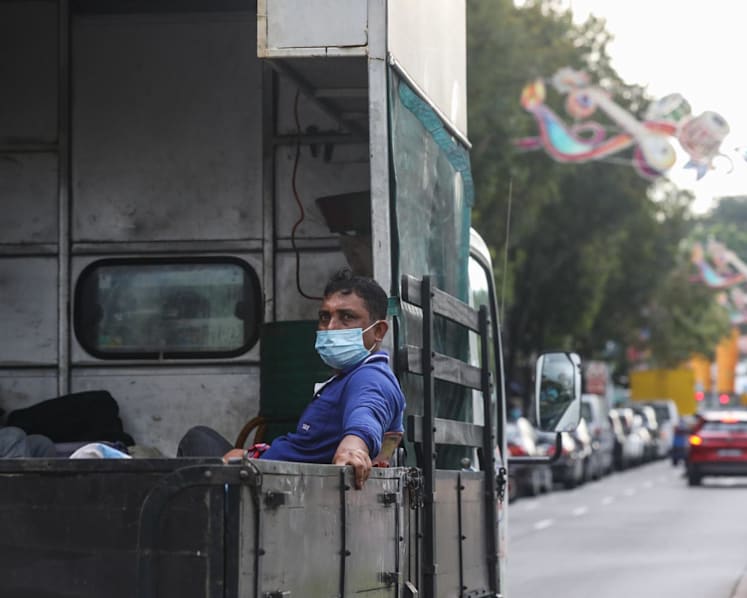 Business groups warn of 'complexities', more traffic jams if firms banned from ferrying workers on back of lorries