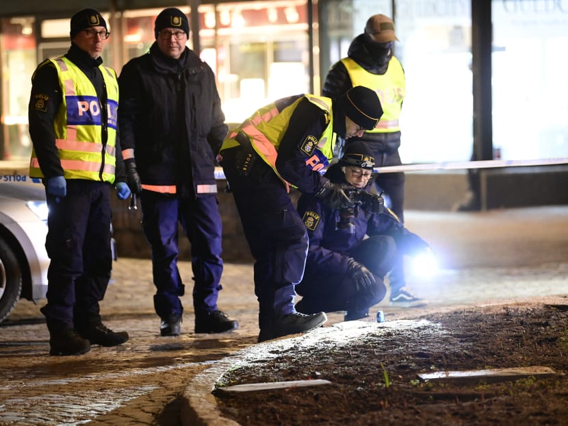 Police investigators work at the scene where a man attacked eight people with a "sharp weapon," seriously injuring two, in the Swedish city of Vetlanda on March 3, 2021.