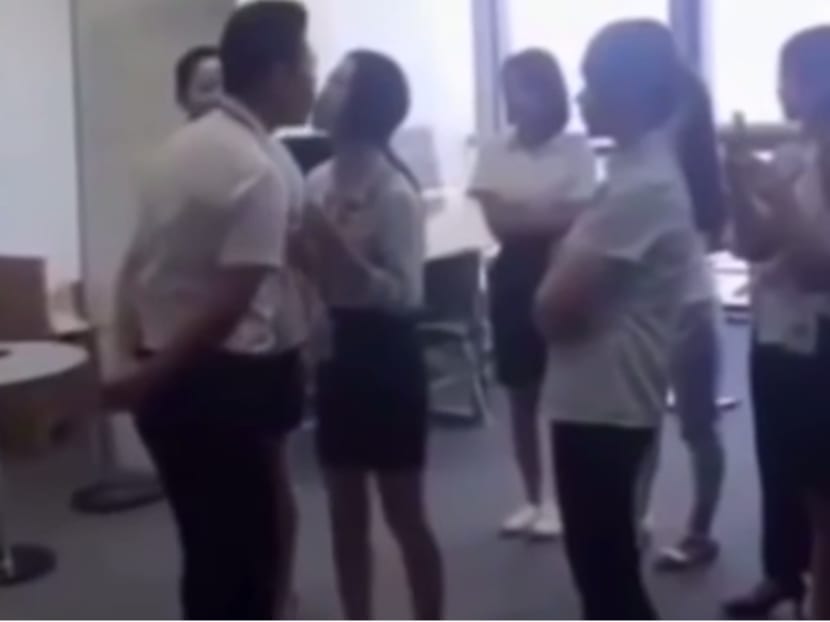 Screengrab from the video showing a company boss 'kissing' what appeared to be his employees. Photo: Youtube screengrab