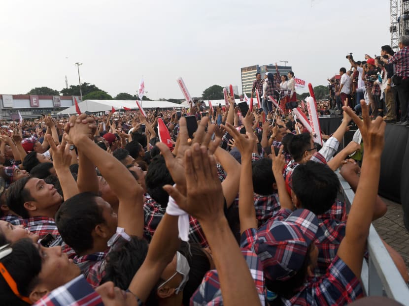 Supporters cheering as Jakarta's governor Basuki Tjahaja Purnama makes his way on stage during his final campaign rally in Jakarta on Feb 11, 2017. Photo: AFP