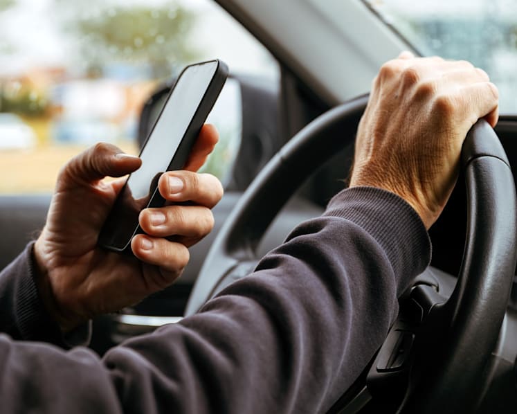 MPs raise concerns over mounted devices, private-hire drivers as law passed to criminalise holding phones while driving
