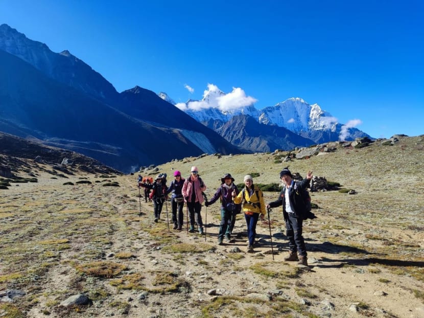 Tourists who booked a trip with Brothers International Tours in Singapore trekking at the base camp of Mount Everest. Tourists who booked a trip with Brothers International Tours in Singapore trekking at the base camp of Mount Everest.