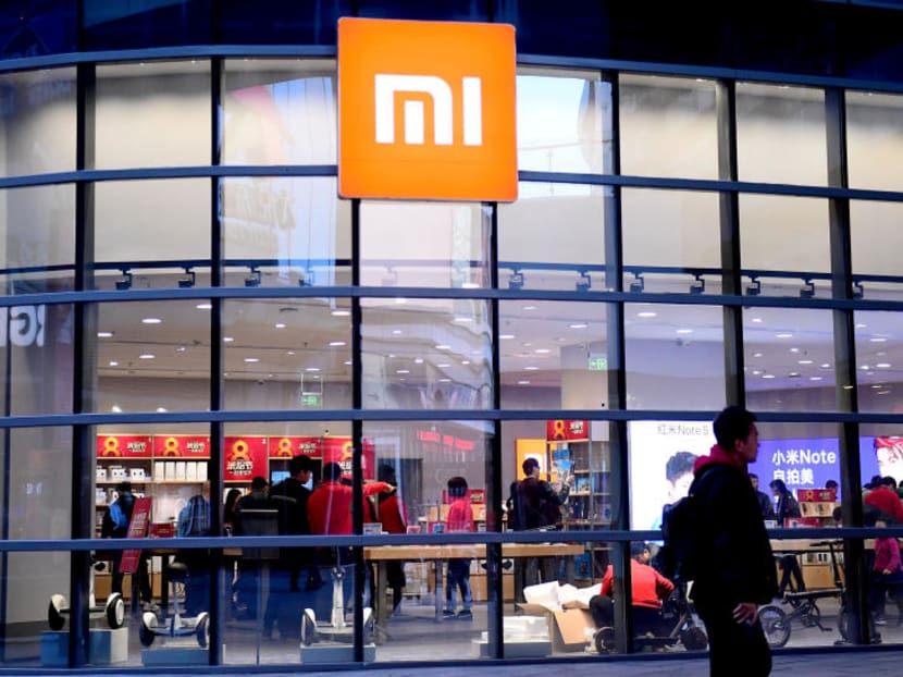 A man walks past a Xiaomi store in Shenyang, China.