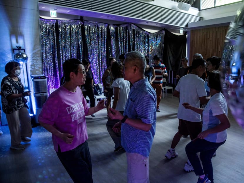 This picture taken on July 31, 2023 shows people taking part in an afternoon disco at a community hall in Hong Kong.