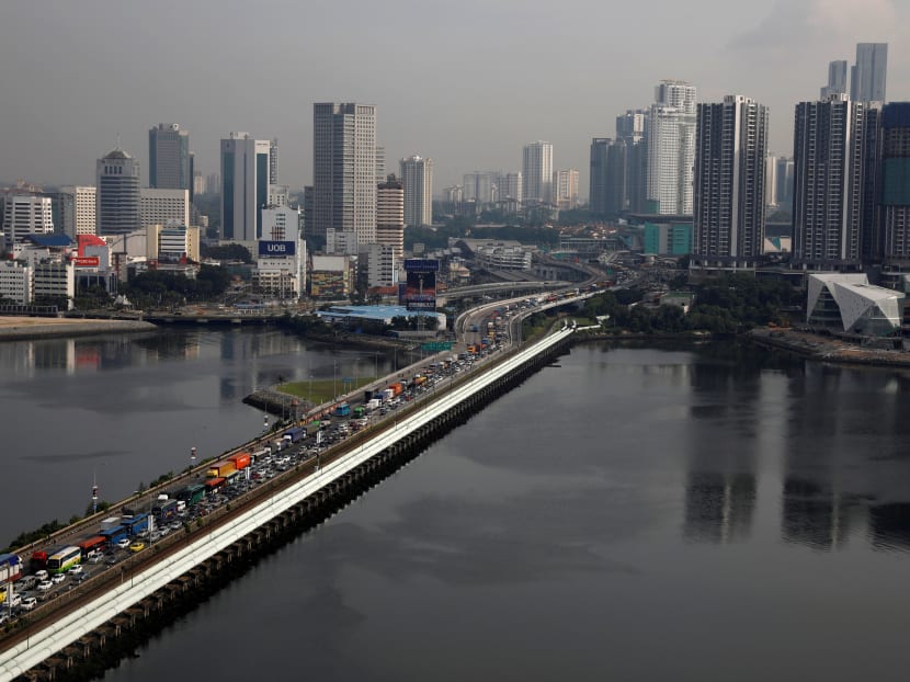 Pipes carrying water from Malaysia to Singapore run alongside the causeway towards the Woodlands Checkpoint in Singapore.