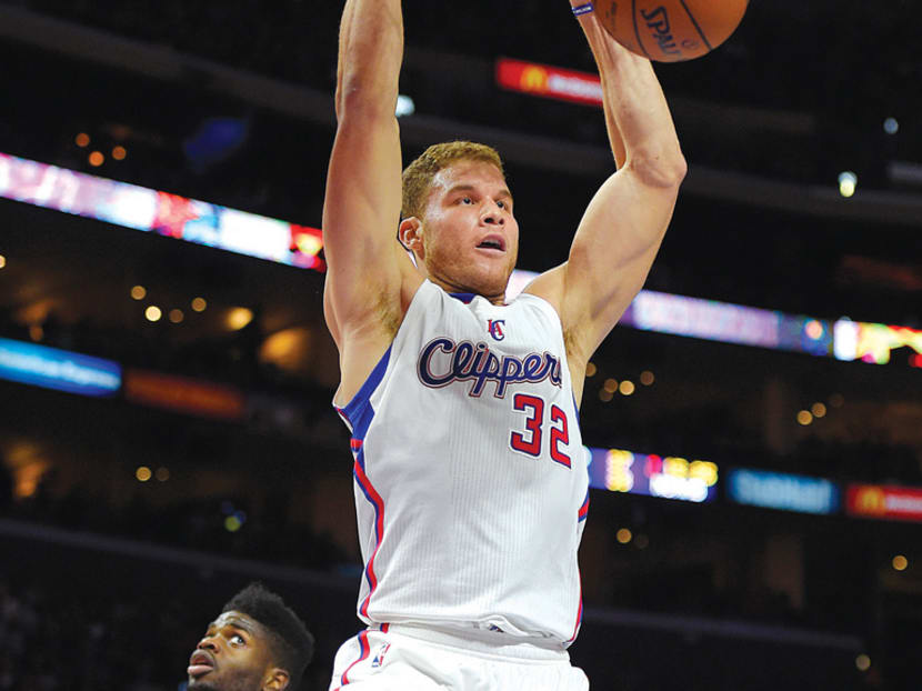 Los Angeles Clippers forward Blake Griffin (in white) dunks as Philadelphia 76ers forward Nerlens Noel looks on during their NBA match in Los Angeles on Saturday. Photo: AP