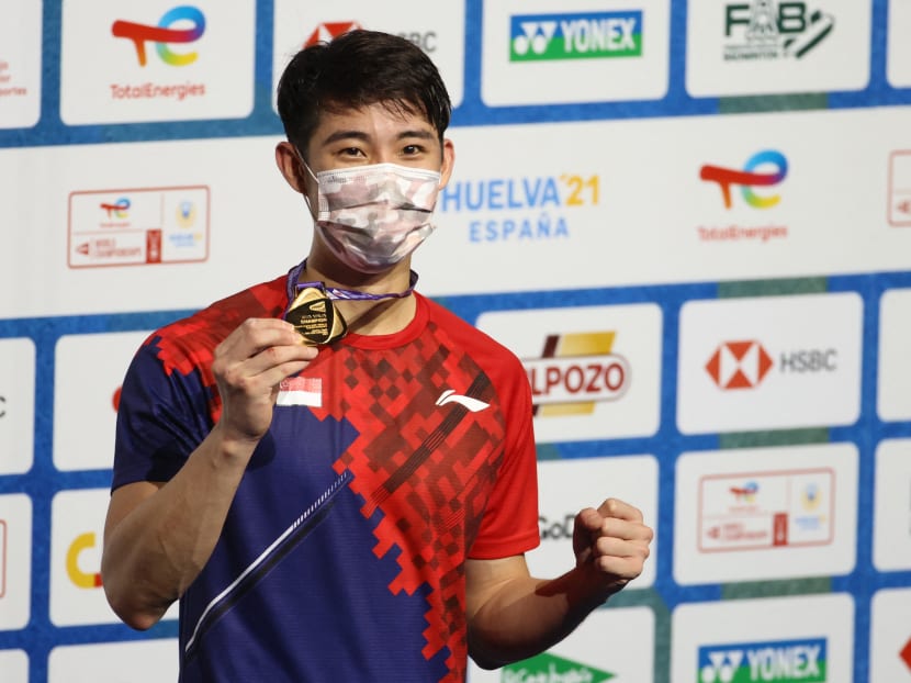 Singapore's Loh Kean Yew celebrates on the podium after winning the men's singles final badminton match of the BWF World Championships in Huelva, on Dec 19, 2021. Singapore's Loh Kean Yew celebrates on the podium after winning the men's singles final badminton match of the BWF World Championships in Huelva, on Dec 19, 2021.