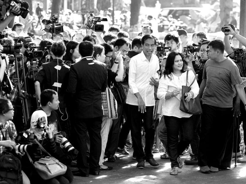 A strong electoral showing by Mr Widodo (seen here with his wife Iriana) and his party would demonstrate an appetite for a different kind of Asian reformist leader. Photo: Reuters