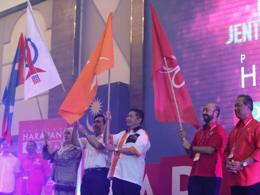 Leaders from the opposition Pakatan Harapan pact wave their party flags during its convention in January 2018.  Photo: Malay Mail Online