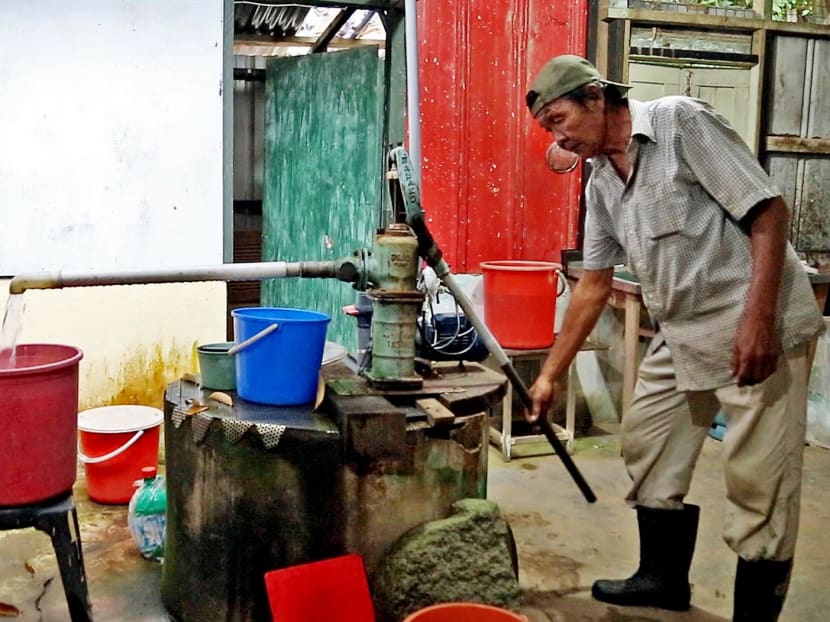 A Pulau Ubin resident pumping water from a well inside a home on the island. Residents there typically boil their water as a precaution. Photo: Raj Nadarajan / TODAY