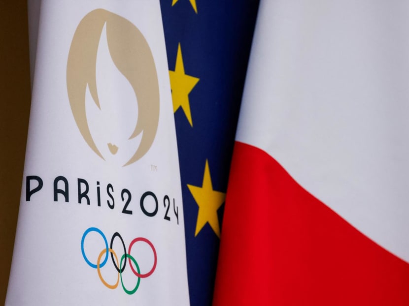 This photograph shows the Paris 2024 Olympics Games flag next to European Union and French flag at the presidential Elysee Palace in Paris, on Jan 12, 2024.