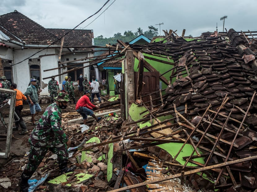 Indonesian soldiers and residents check damaged houses in Malang, East Java, Indonesia on April 11, 2021, a day after a 6.0-magnitude quake struck off the coast of Indonesia’s main Java island.