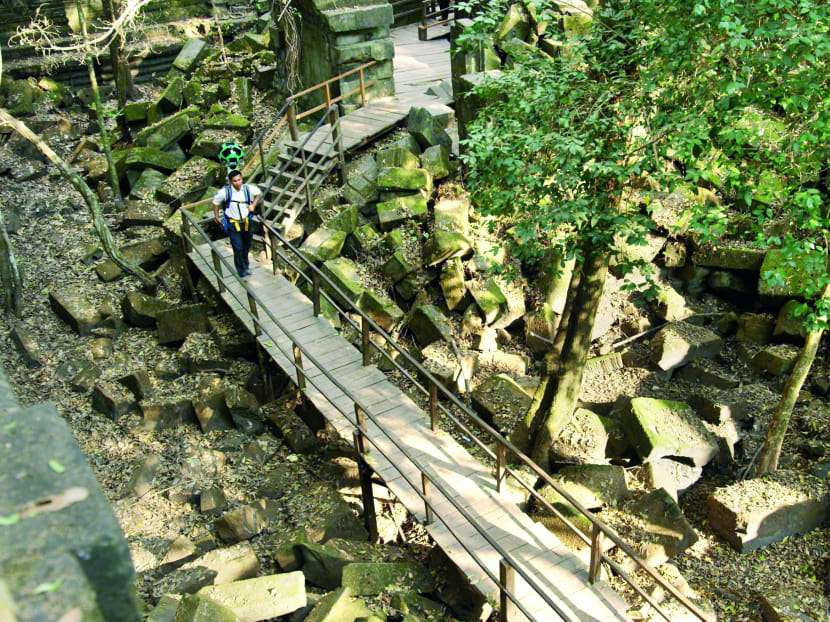 A trekker from Google walking through Angkor, a World Heritage site. More than 90,000 panoramic shots have been joined to form 360-degree views of the exteriors and interiors of Angkor’s temples. Photo: Google