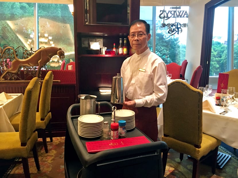 Mr Raymond Ong, 68, who has worked as a busser at Lawry's The Prime Rib Singapore for the past two months. He uses a trolley with wheels to move cutlery and crockery around, as opposed to trays, which he found heavy and more dangerous as an older worker. Photo: Louisa Tang
