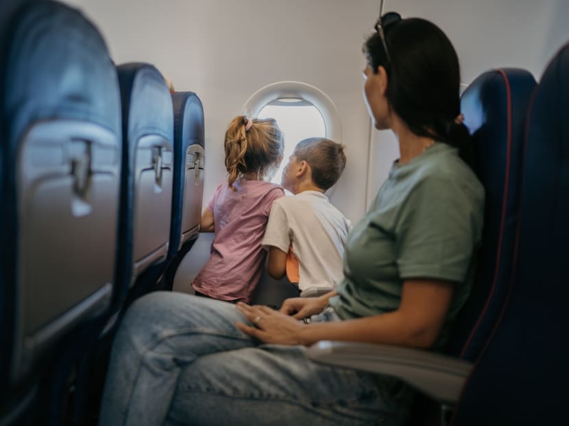 Stock image of a mother traveling with two children on a plane. Stock image of a mother traveling with two children on a plane.