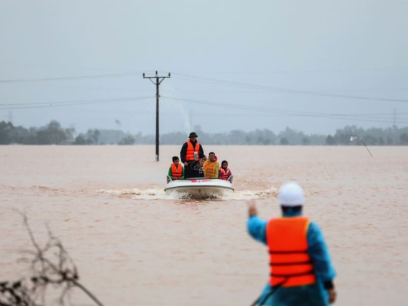 Rescue personnel carrying villagers in a boat through floodwaters in central Vietnam's Ha Tinh province on Oct 20. Rescue personnel carrying villagers in a boat through floodwaters in central Vietnam's Ha Tinh province on Oct 20.