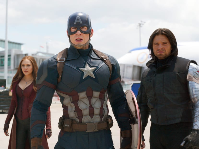 This image released by Disney shows Elizabeth Olsen, left, Chris Evans and Sebastian Stan in a scene from Marvel's "Captain America: Civil War," opening in theaters nationwide on May 6, 2016. (Disney/Marvel via AP)