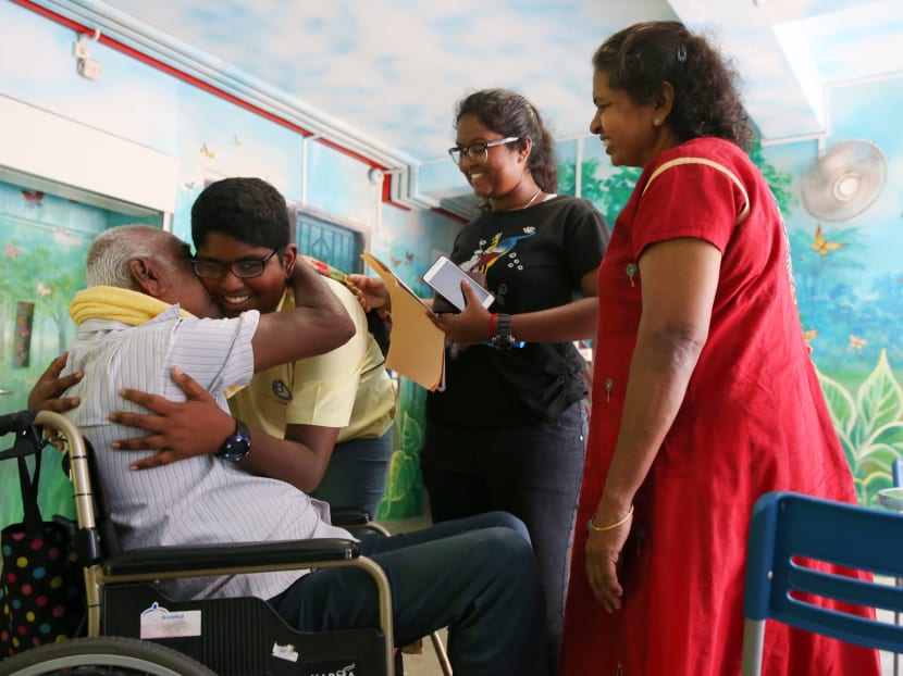 Sri John Albert David, 12, is congratulated by his granparents and elder sister after collecting his PSLE results at Da Qiao Primary School on Nov 24. Sri John, who was diagnosed with dyslexia when he entered primary school, qualified to study in the Normal (Academic) stream in secondary school. Photo: Koh Mui Fong/TODAY