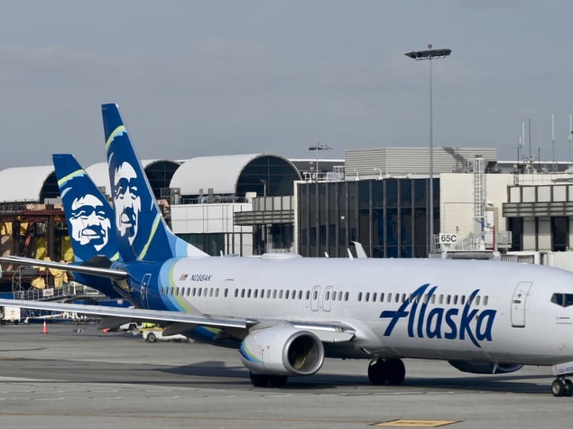 An Alaska airlines plane seen at Los Angeles International Airport (LAX) on January 11, 2023. Airlines and safety bodies around the world grounded some versions of the Boeing 737 MAX 9 jets pending inspections Sunday (Jan 8), with dozens of flights cancelled over the weekend after a panel blew out of one of the planes over the western US state of Oregon.