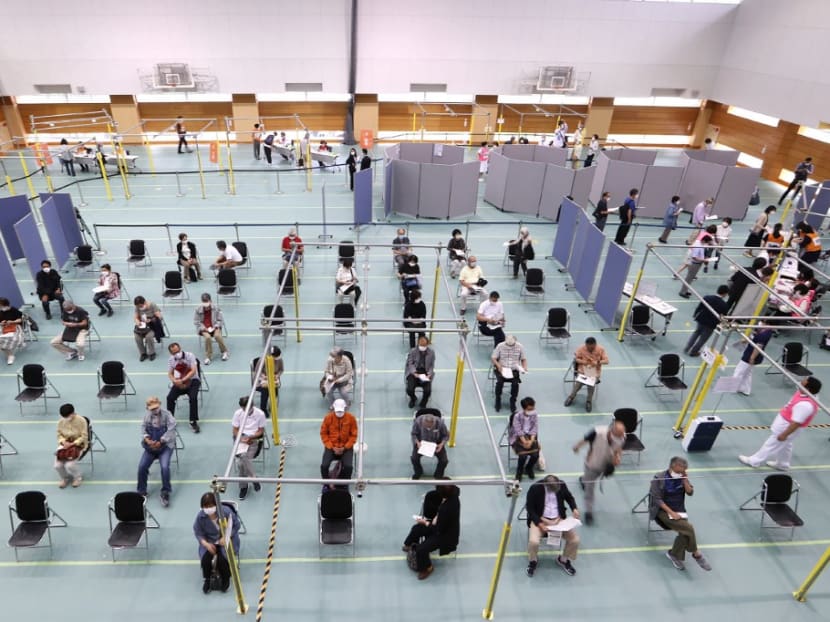 People gather to receive the Moderna coronavirus vaccine at a newly-opened mass vaccination centre in Toyoake City, Aichi prefecture on May 24, 2021.