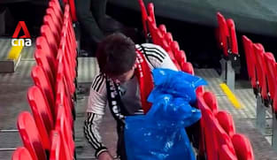 Japanese football fans clean up after themselves after Japan-England match
