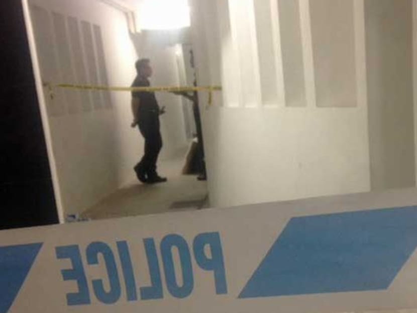 Police cordon off the corridor leading to the crime scene on the 15th floor of Blk 636B at Senja Road, Bukit Panjang. Photo: Leong Wai Kit/Channel NewsAsia