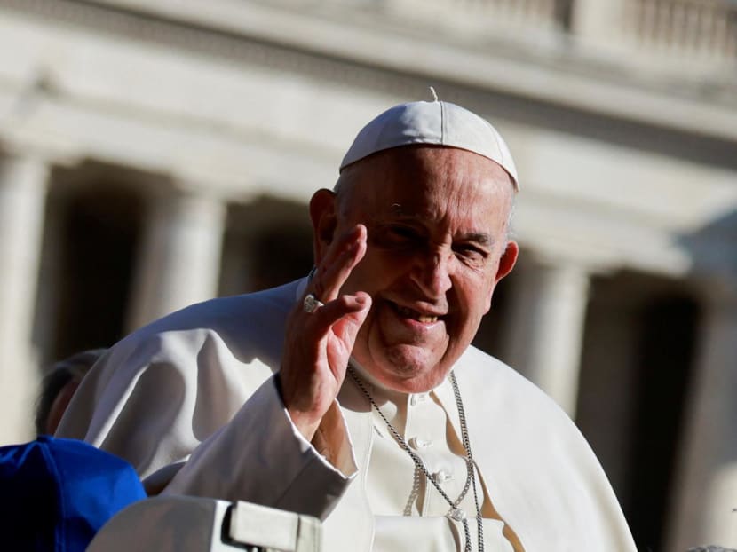 Pope Francis greeting people as he arrived for the weekly general audience in St Peter's Square at the Vatican on March 20, 2024.