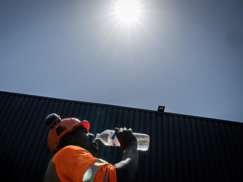 A worker drinks water in a construction site in Savenay, outside Nantes, on July 18, 2022, as a heatwave hits France. A worker drinks water in a construction site in Savenay, outside Nantes, on July 18, 2022, as a heatwave hits France.