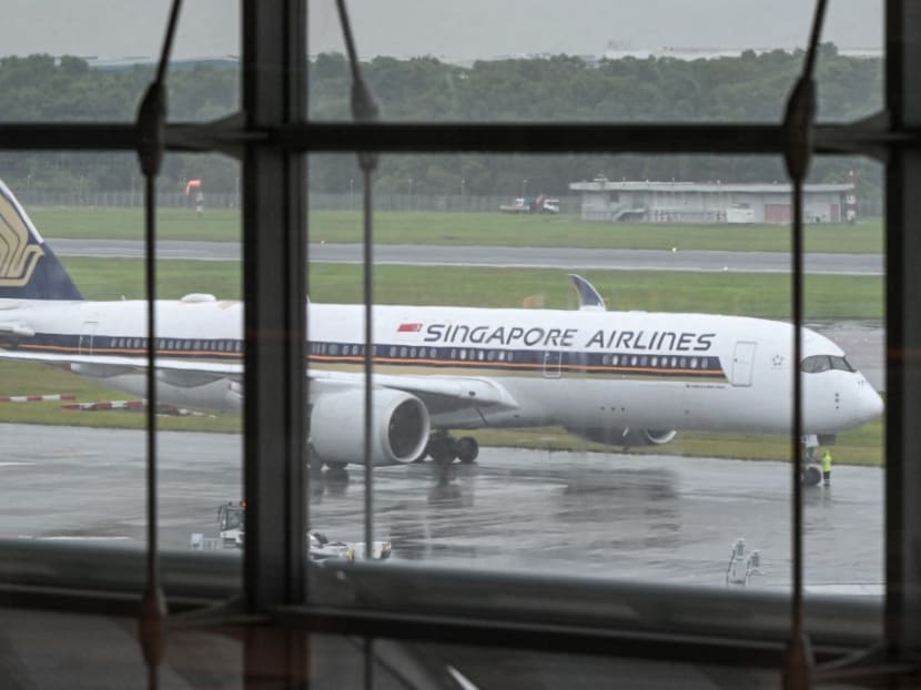 A Singapore Airlines plane waits to depart at Changi International Airport in Singapore on Dec 2, 2021. A Singapore Airlines plane waits to depart at Changi International Airport in Singapore on Dec 2, 2021.