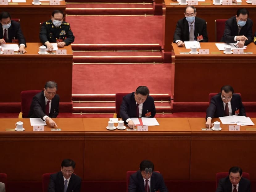 China's president Xi Jinping (centre) votes on changes to Hong Kong's election system during the closing session of the National People's Congress at the Great Hall of the People in Beijing on Thursday, March 11, 2021.