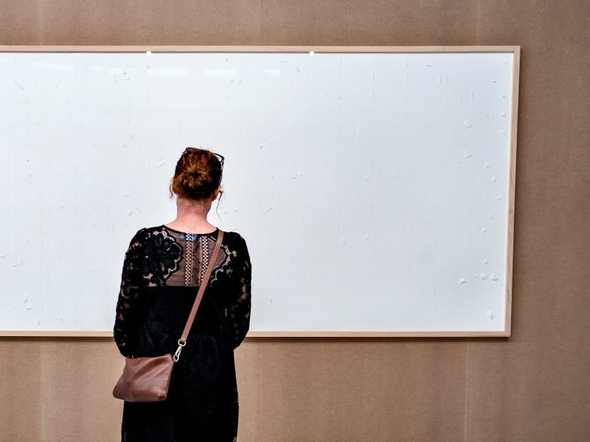 A woman looks at an art installation titled "Take the Money and Run" by Danish artist Jens Haaning at the Kunsten Museum of Modern Art, in Aalborg, Denmark on Sept 28, 2021. A woman looks at an art installation titled "Take the Money and Run" by Danish artist Jens Haaning at the Kunsten Museum of Modern Art, in Aalborg, Denmark on Sept 28, 2021.