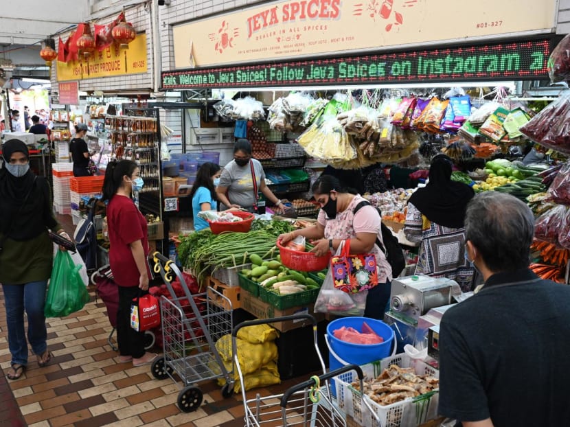 People shop for groceries at a market in Singapore on Oct 9, 2021.