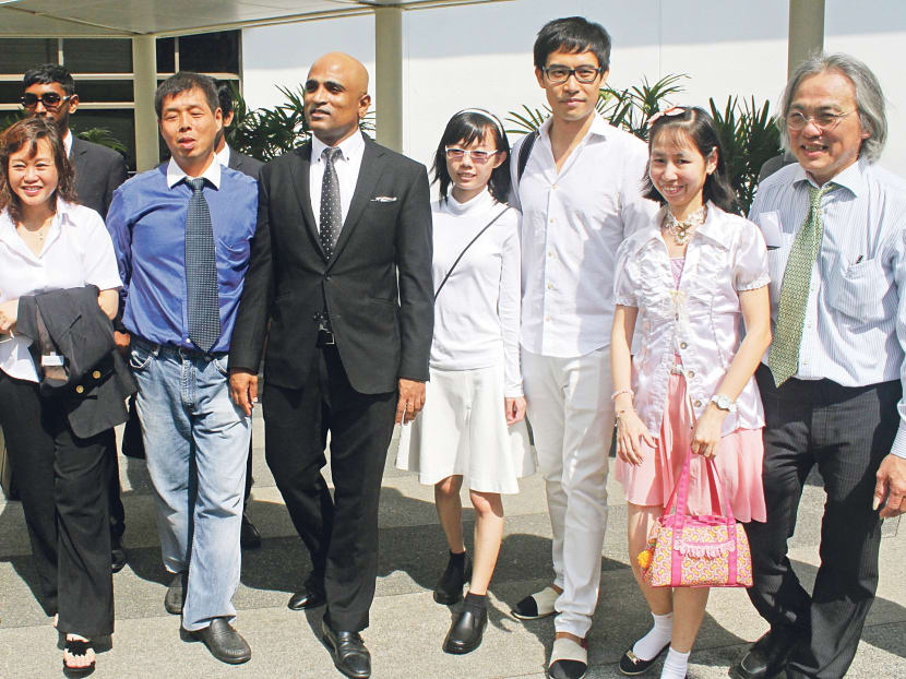 (From left) Low Wai Choo, Goh Aik Huat, lawyer M Ravi, Han Hui Hui, Roy Ngerng, Chua Siew Leng and Koh Yew Beng at the State Courts yesterday. The protesters posed gamely for photos, but declined to speak to the media. Photo: Channel NewsAsia