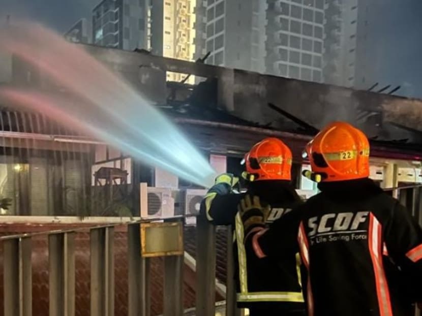 Firefighters conducting dampening down operations at affected houses along East Coast Road after a blaze on Jan 10, 2023. Firefighters conducting dampening down operations at affected houses along East Coast Road after a blaze on Jan 10, 2023.