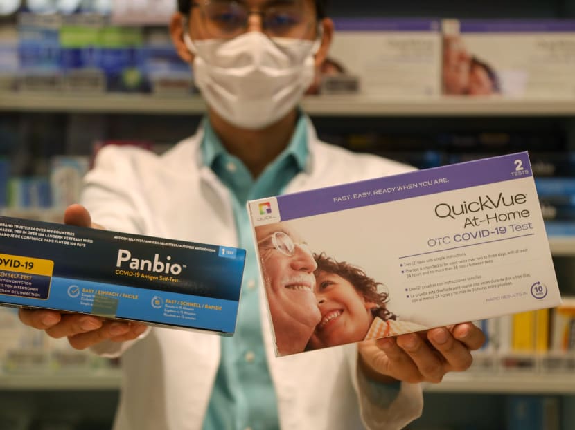 A pharmacist at Unity Pharmacy in VivoCity mall holding up the Abbott Panbio and Quidel QuickVue ART kits on June 16, 2021. A pharmacist at Unity Pharmacy in VivoCity mall holding up the Abbott Panbio and Quidel QuickVue ART kits on June 16, 2021.