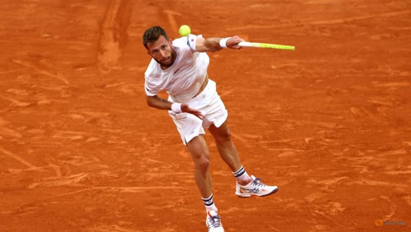 Djokovic saves set point, battles past Moutet to stay on course for record Grand Slam