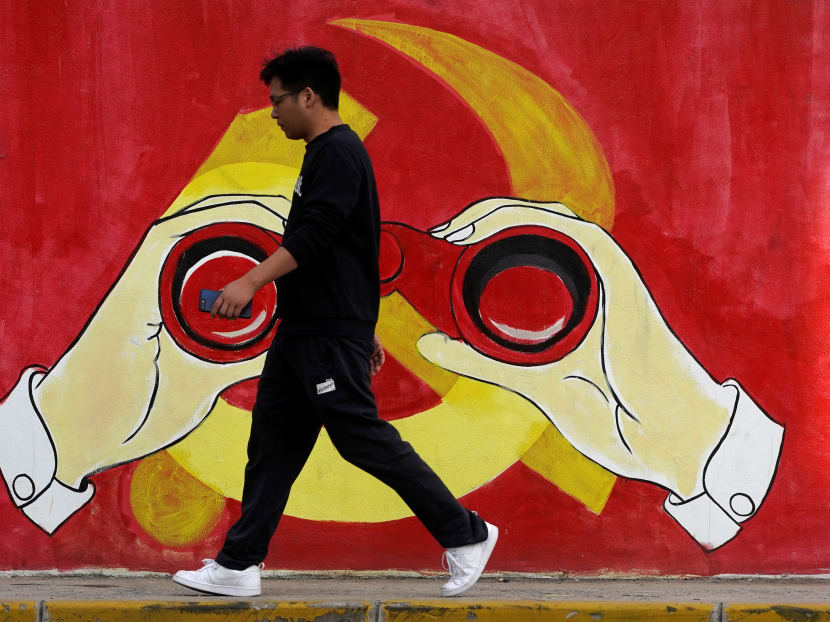 A man walks next to a mural showing an image of the Chinese Communist Party's emblem along a street in Shanghai on Sept 25. A man walks next to a mural showing an image of the Chinese Communist Party's emblem along a street in Shanghai on Sept 25.