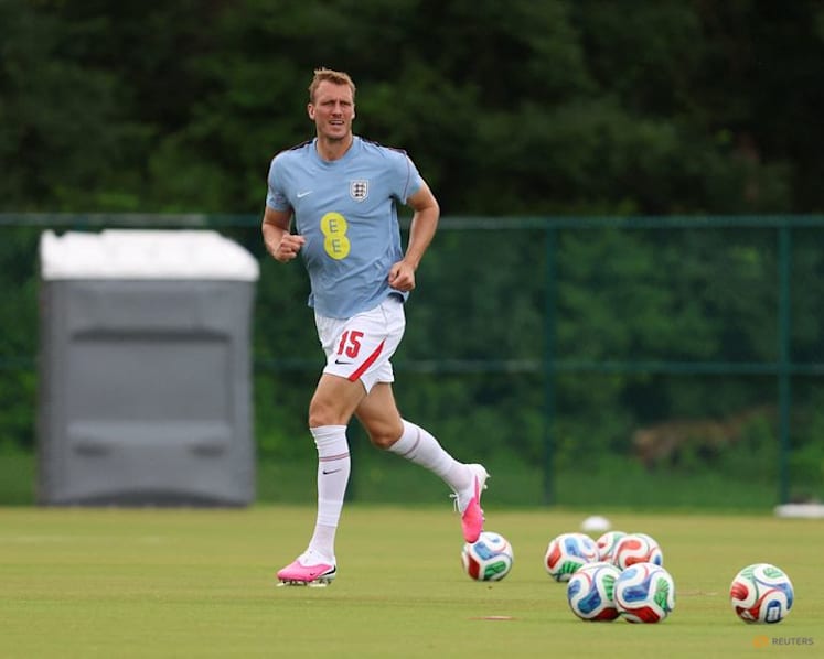 England's Burn swaps football boots for cowboy boots during break between games