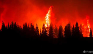Huge California fire grows as heat spikes again across state