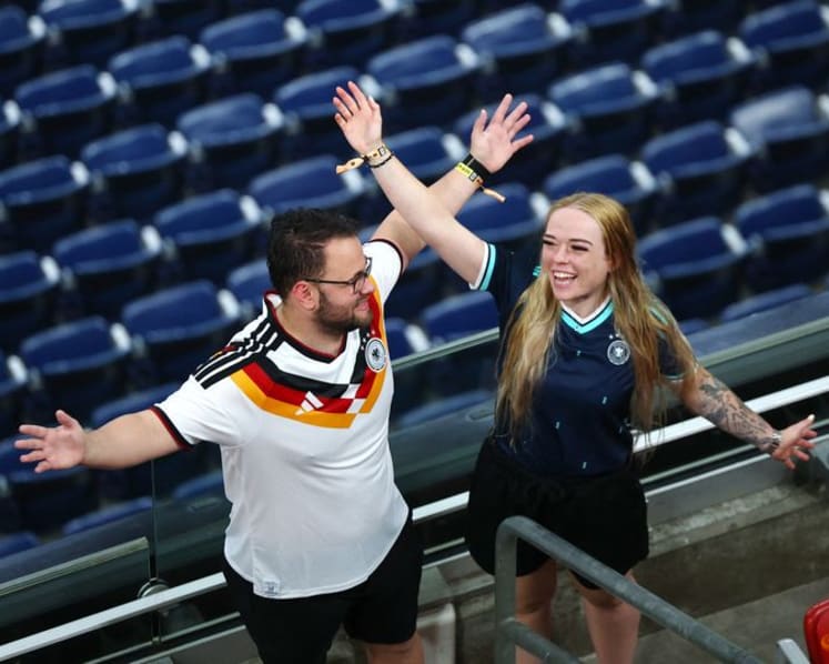 Rain sends Germany and Curacao fans on pre-match hunt for umbrellas and beer