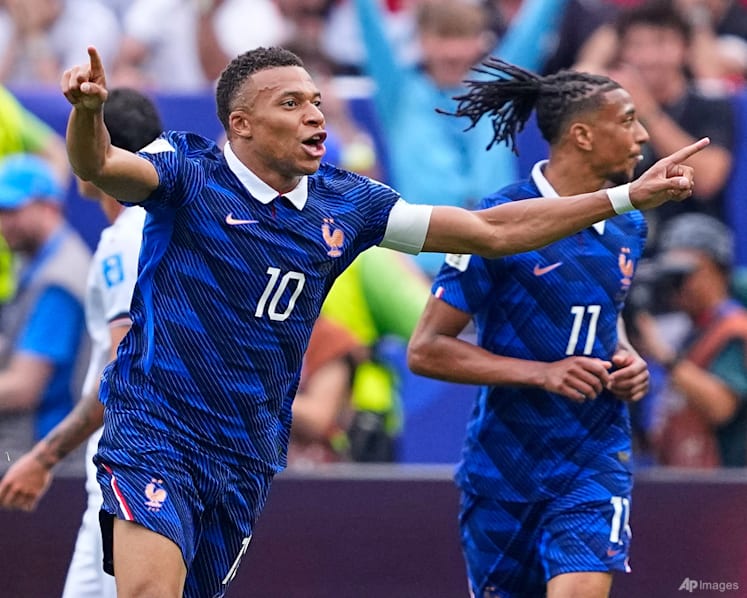 Mbappe double sends France into World Cup knockout rounds after weather delay