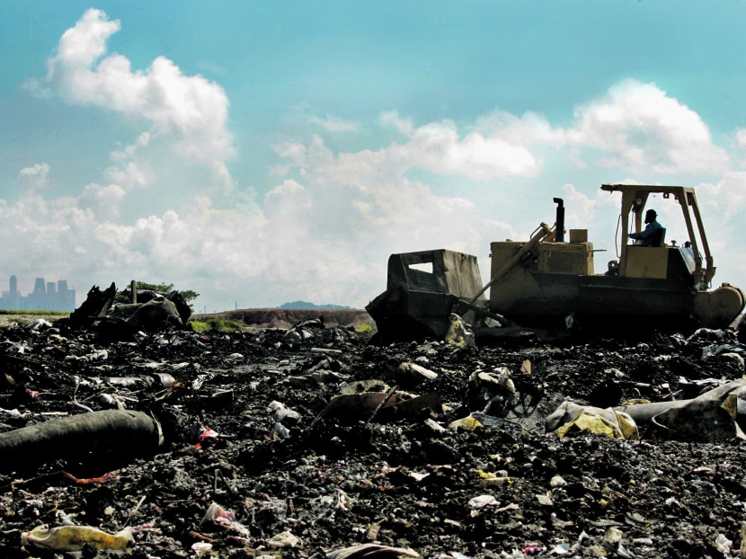 Bulldozers and compactors are used to level and compact the waste at a landfill cell at the Semakau Landfill, which is Singapore's only landfill for waste disposal. 