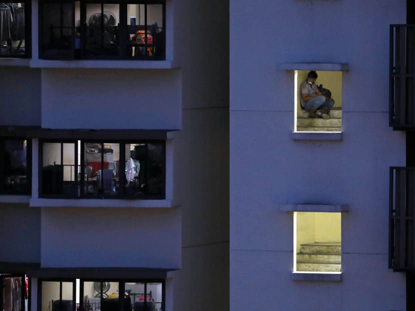 A migrant worker uses his phone at a dormitory block in Toh Guan on July 15, 2021. Unlike the wider community, migrant workers residing in dormitories have been largely confined to their rooms and worksites over the past 15 months. A migrant worker uses his phone at a dormitory block in Toh Guan on July 15, 2021. Unlike the wider community, migrant workers residing in dormitories have been largely confined to their rooms and worksites over the past 15 months.