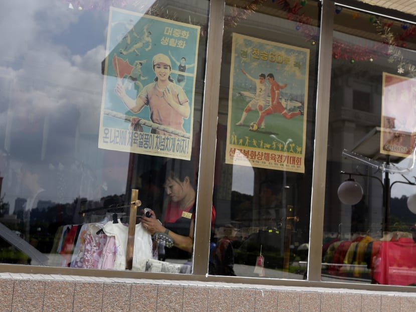 A North Korean shop assistant works at a shop in Pyongyang on July 29, 2013.